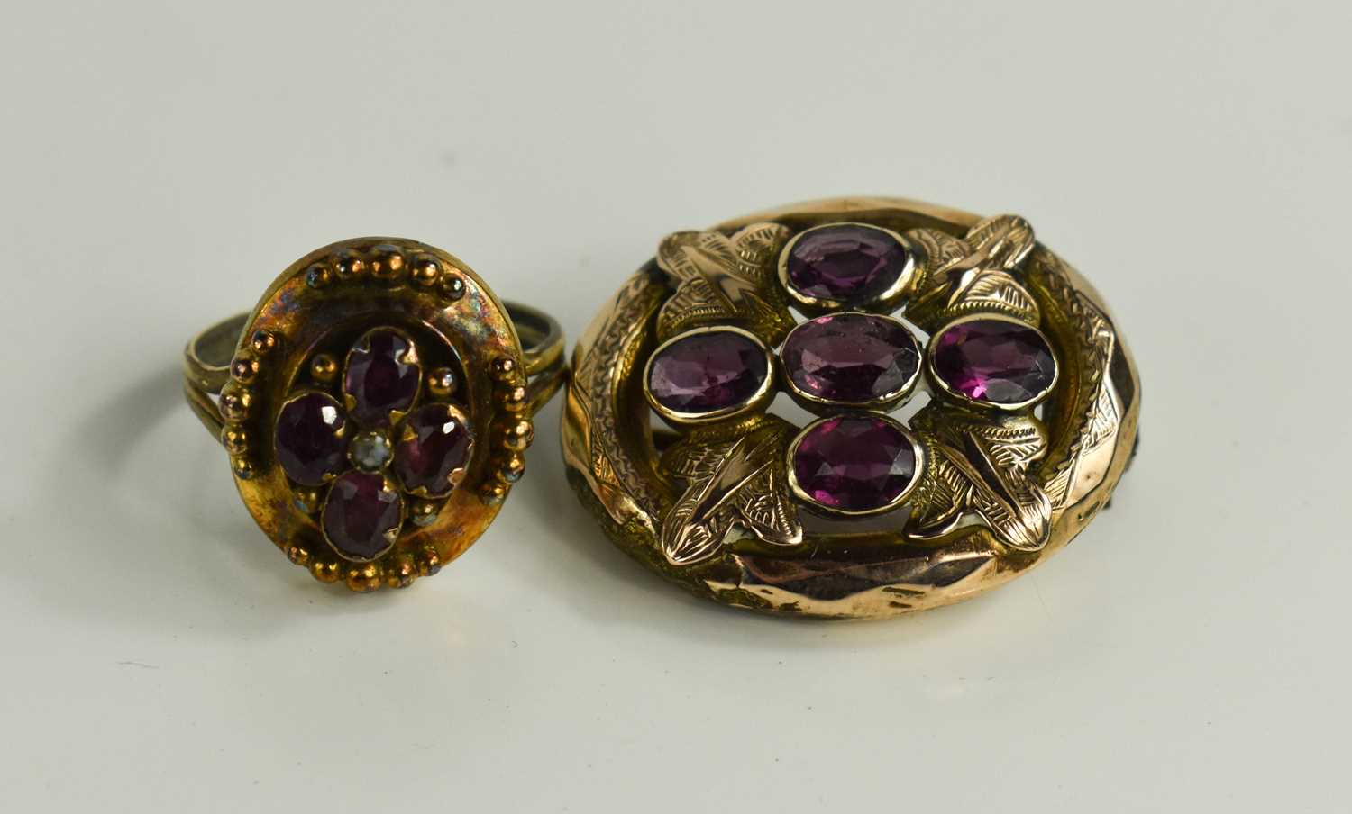 A 19th century rose gold coloured brooch set with five amethysts in a cruciform, with scrolled - Bild 2 aus 3