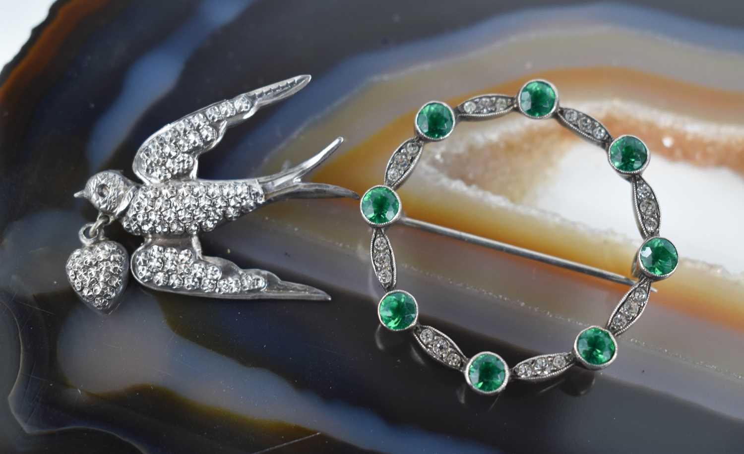 Two mid 20th century vintage brooches, comprising one set with emerald green and white paste, the