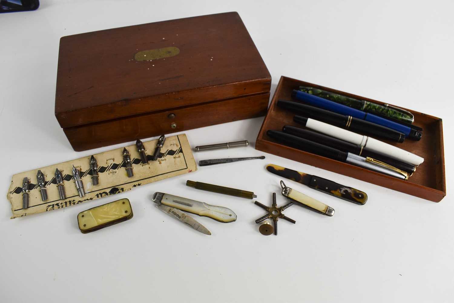 A group of vintage pens, nibs, mother of pearl and silver fruit knife, Victorian mahogany box, and