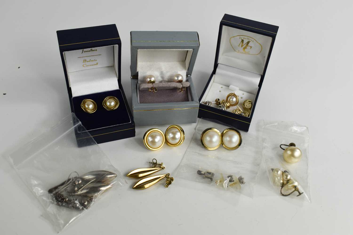 A group of four pairs of 9ct gold earrings, comprising three pairs set with pearls and a pair of