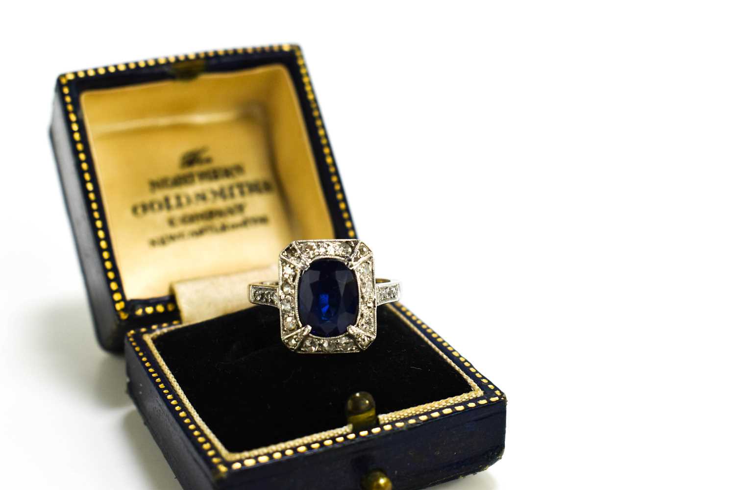 An Art Deco 18ct gold, platinum, sapphire and diamond ring, the central oval cut stone of