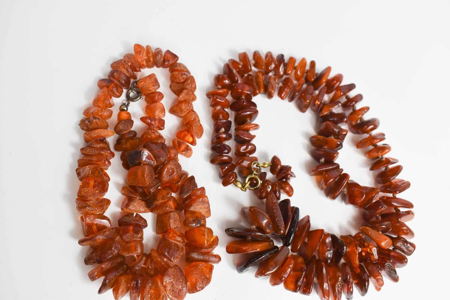 A string of vintage Baltic amber, of natural, polished cut, 50.0g, 62cm long, together with a string