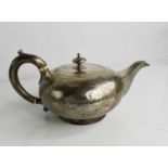 A silver tea pot, engraved with decoration to the body and spout, London 1925, 14.37toz.