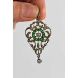 A stunning 19th century paste and silver pendant, set with a circle of green emerald cut paste
