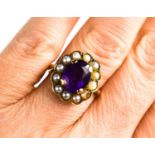 A 9ct gold amethyst and seed pearl ring, with central amethyst of approximately 10 by 8mm,