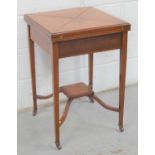 An Edwardian mahogany folding quarter top card table with square tapered legs raised on castors