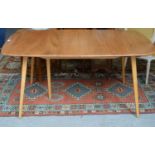 A mid-century Ercol elm extending dining table.