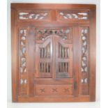 A Indonesian style wall mirror in the form of a window with two shutters, 70cm by 60cm.