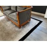 A large rug by Stephanie Bouquet, mink with black border, 286cm by 386cm