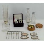 A group of collectable items to include a silver topped bottle, decanter labels, short glasses,