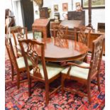 An American Chippendale style dining table with extra leaf and six matching dining chairs