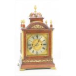 A walnut and mahogany bracket clock, the domed top surmounted by acorn finial, the sides having fret