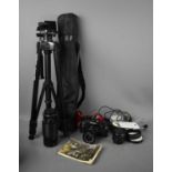 A Canon A-1 35mm SLR camera with 70-210mm lens and various accessories to include tripod.