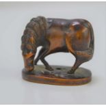 An early 20th century Japanese boxwood netsuke, in the form of a grazing horse, 3.1cm high.