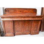 A Victorian mahogany breakfront sideboard with shaped and carved back and frieze drawer above two