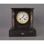 A Victorian slate mantle clock with marble columns flanking a Roman numeral dial, 27cm high.