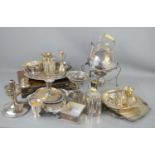 A quantity of silver plated items to include a tea kettle with stand and burner, canteen of cutlery,