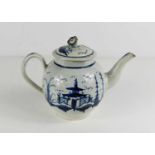 A late 18th/early 19th century blue and white pottery teapot, the cover with flower form finial,