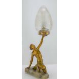 An Art Deco style spelter lamp of a lady raised on an onyx base.