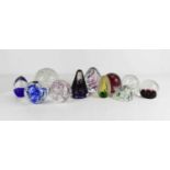 A group of eleven glass paperweights, of various design including Langham glass example.