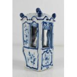 A 19th century Delft blue and white carriage, modelled with a lady and dog seated within, 11cm high.