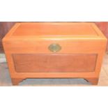 A Chinese style camphor wood chest together with a mid-century coffee table.