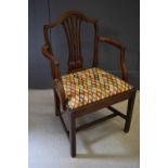 A 19th century mahogany armchair with pierced splat and upholstered drop in seat.