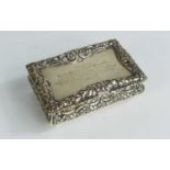 A William IV silver snuff box, embossed with floral decoration and the lid engraved with