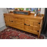 A Robert 'Mouseman' Thompson sideboard with adzed top comprising two cupboards with three central