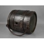 An antique oak coopered barrel, with iron strapwork and handle, 24cm high.