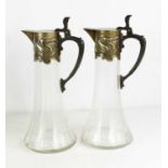 A pair of Art Nouveau silver plated claret jugs.