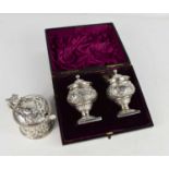 A pair of silver pepperettes together with a mustard pot, 6.94toz without glass liner.