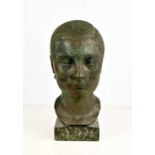A contemporary bronze sculpture of a female head, raised on a marble plinth, of green and brown