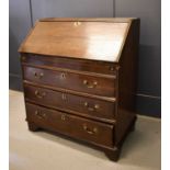 A George II oak provincial bureau, the fall revealing fitted interior of three panelled drawers