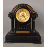 A Victorian slate mantle clock, the four columns flanking the center piece with gilt Arabic dial,