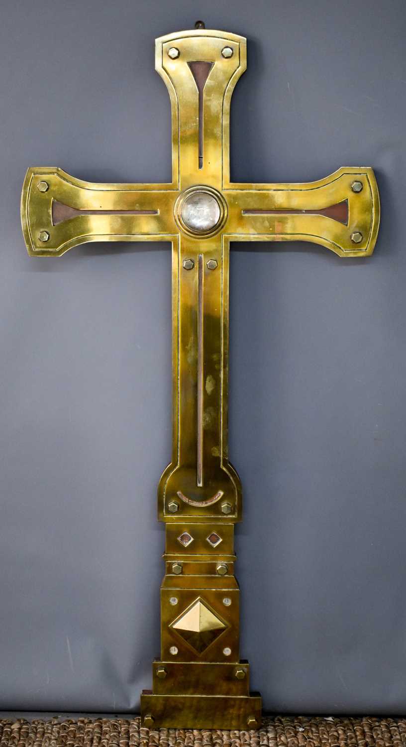 An Arts & Crafts period brass ecclesiastical cross with large glass cabochon to the center, 130cm.