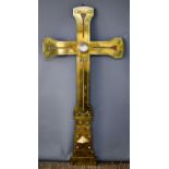 An Arts & Crafts period brass ecclesiastical cross with large glass cabochon to the center, 130cm.