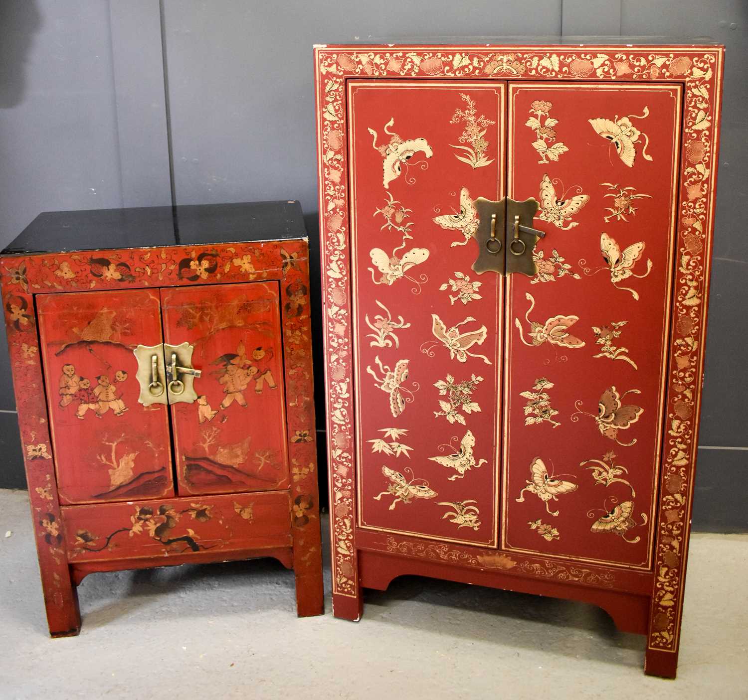 Two Chinese red lacquered cabinets, one decorated with gilded butterflies and flowers, the larger