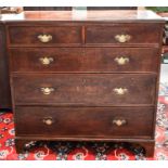 A 19th century oak chest of drawers, with two short over three long graduated drawers, raised on