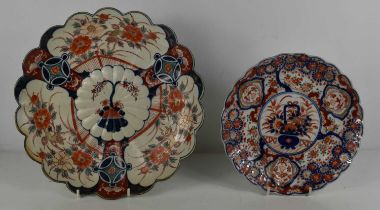 A 19th century Imari dish, with scalloped edge, and flowering plant painted to the centre,