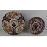 A 19th century Imari dish, with scalloped edge, and flowering plant painted to the centre,