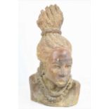 An African carved soapstone bust of a native women with braided hair, signed P.Mosh, 33.5cm high.