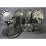 A selection of pewter chargers, tankards, plates, jug and a trinket dish centred with a squirrel.