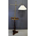 An antique black lacquered and brass chinoiserie reading lamp, the height adjustable arm above a