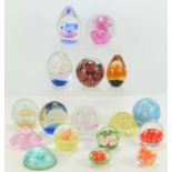 A group of glass paperweights of various style and form.
