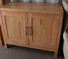 A beech cabinet with two panelled doors, 85cm high by 101cm wide by 41cm deep.