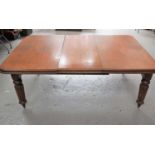 A Victorian mahogany wind out dining table with extra leaf, 69cm high by 180cm by 120cm.