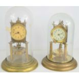 Two German torsion pendulum clocks, both with glass domes,