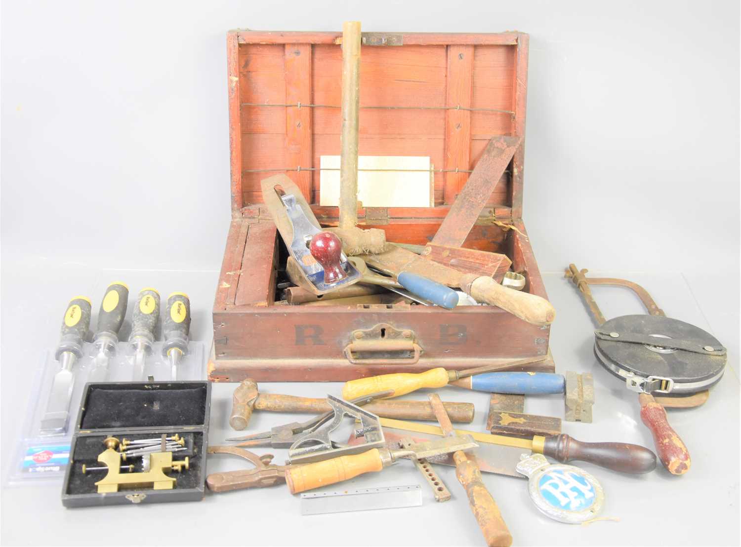 A group of vintage tools to include a Record plane, various chisels, spanners and other items.