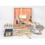 A group of vintage tools to include a Record plane, various chisels, spanners and other items.